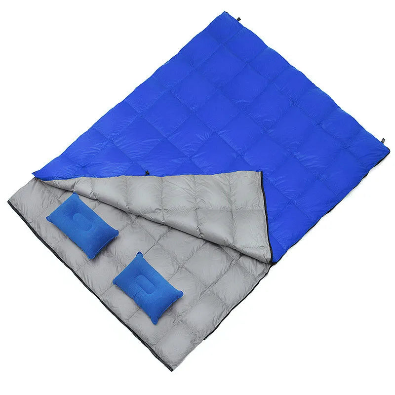 Load image into Gallery viewer, Blue and gray sleeping bag with two blue pillows on a white background
