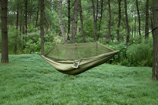 Green hammock with mosquito net in a forest setting, labeled 'Single size 260 x 140cm'.