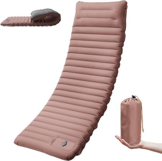 Pink inflatable camping mat with a hand holding its carrying bag on a white background
