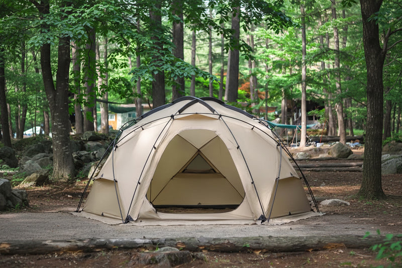 Load image into Gallery viewer, Beige camping tent in a forest setting with 'Mobi Garden' branding.
