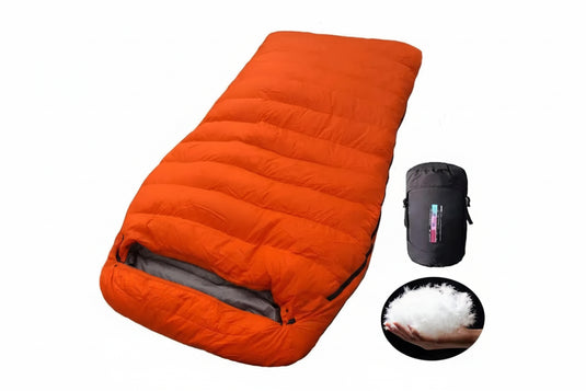 Orange sleeping bag with duck down filling, packaging, and fluffy material close-up on a white background.