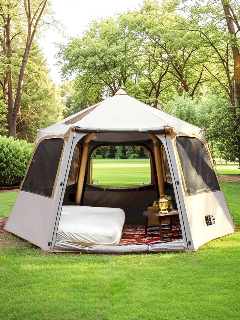 Load image into Gallery viewer, Camping tent with interior setup in a park setting

