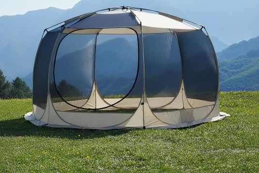 Tent with ultrafine mesh on grassy area with mountain background