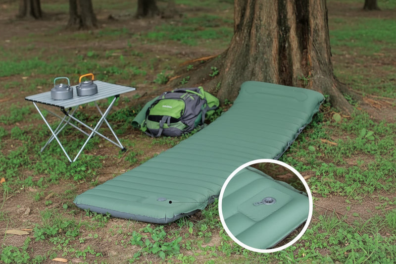 Load image into Gallery viewer, A green inflatable camping mattress in a forest setting.
