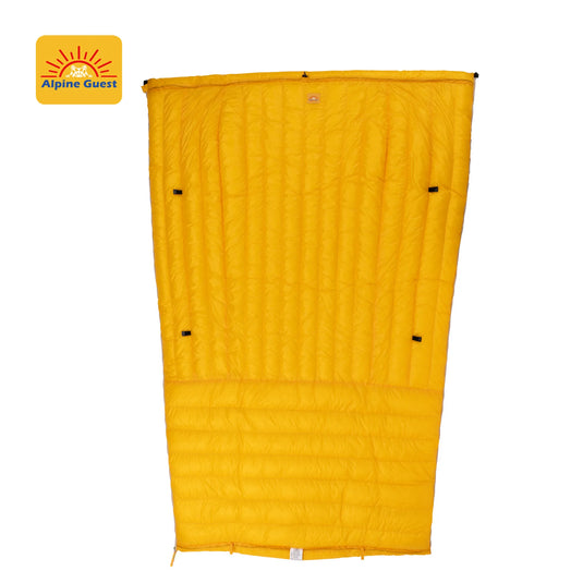 Yellow sleeping bag with Alpine Guest logo on a white background