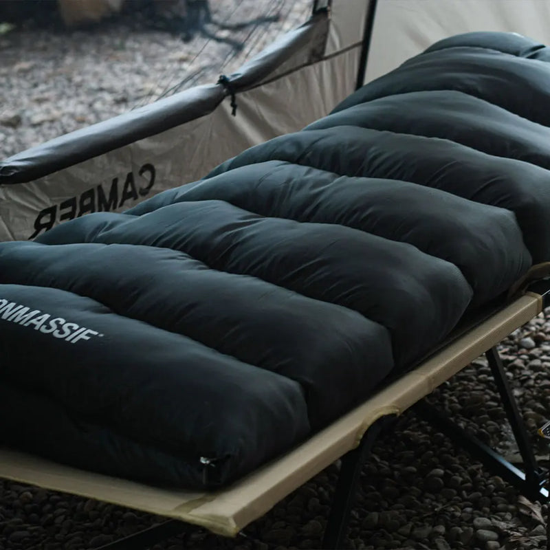 Load image into Gallery viewer, Black inflatable camping mattress on a camping cot with visible branding.
