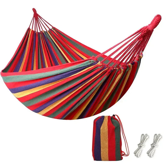 Colorful striped hammock with carrying bag and ropes on a white background