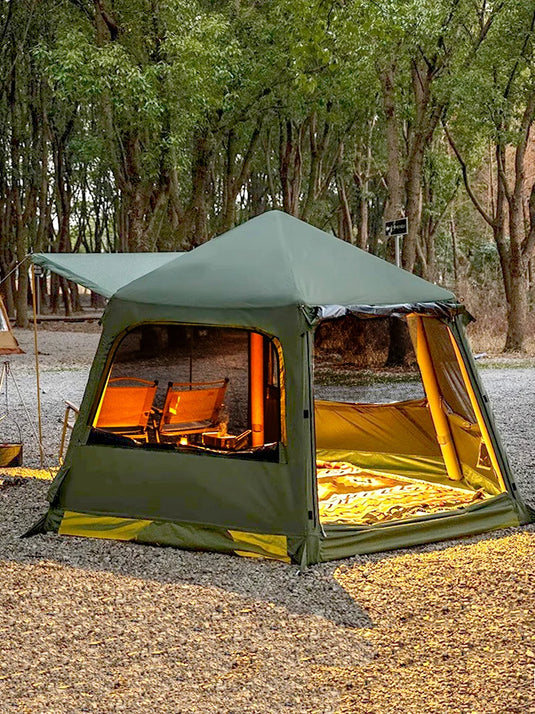 Green camping tent with yellow interior in a forest setting