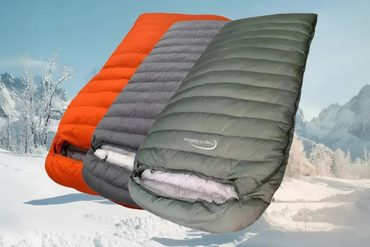 Mummy style double sleeping bag with orange, gray, and green sections on a snowy background.