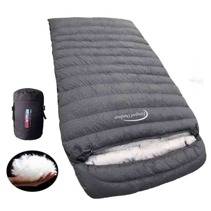 Load image into Gallery viewer, Gray sleeping bag with white interior and black compression sack on a white background
