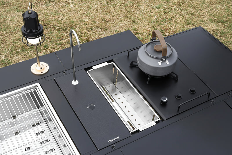 Load image into Gallery viewer, Camping sink with water dispenser and kettle on a grassy background
