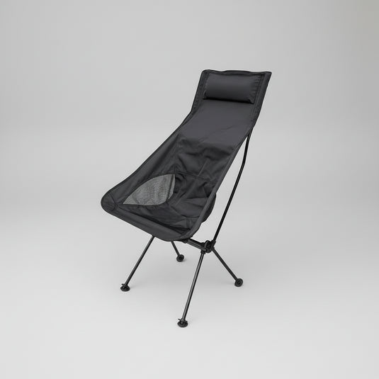 Black camping chair on a grassy area with trees and a hammock in the background