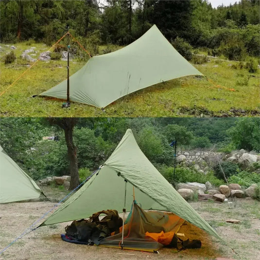 Green camping tarp set up in a natural outdoor setting with trees and rocks.