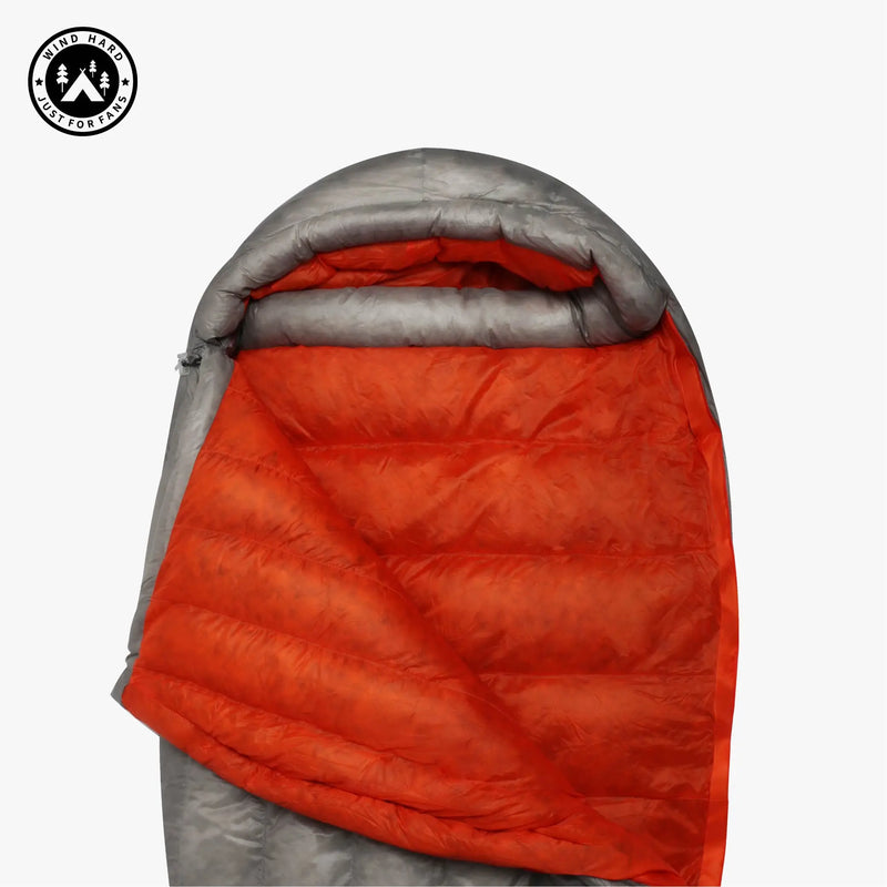 Load image into Gallery viewer, Orange and gray sleeping bag with a visible brand logo on a white background
