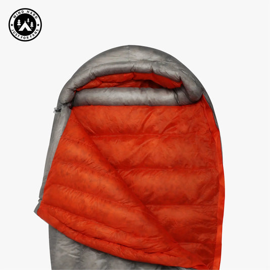 Orange and gray sleeping bag with a visible brand logo on a white background