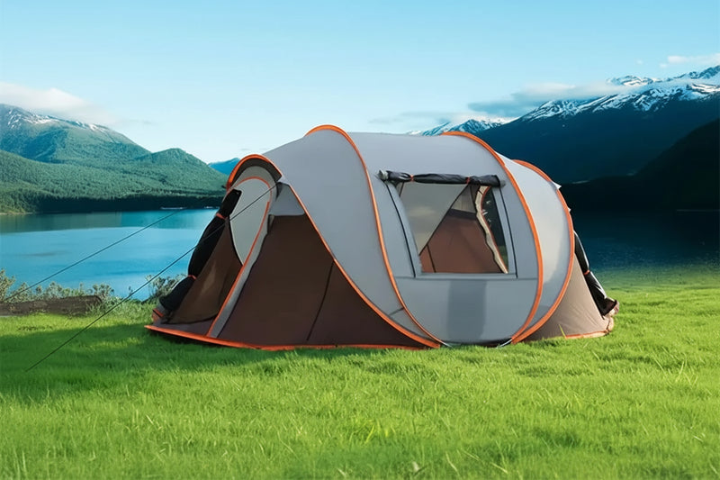 Load image into Gallery viewer, Camping tent on grass with scenic mountains and lake in the background, text 'A Home for Travelers'.
