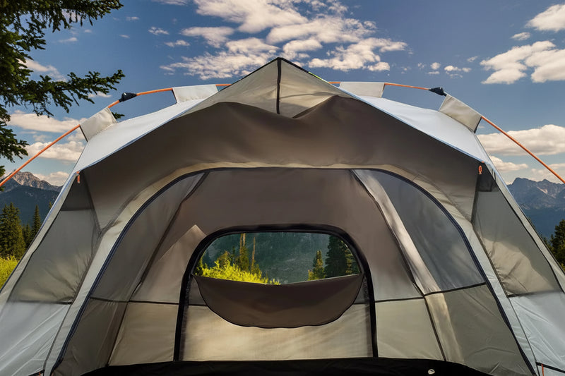 Load image into Gallery viewer, Tent with a view of trees and mountains through the door, against a blue sky.
