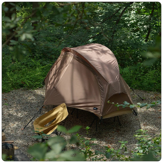 Brown tent set up in a forested area