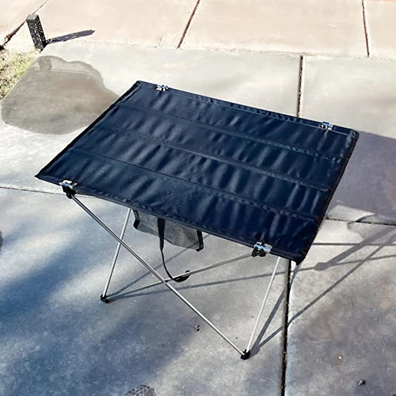 Load image into Gallery viewer, Black folding table on a concrete surface
